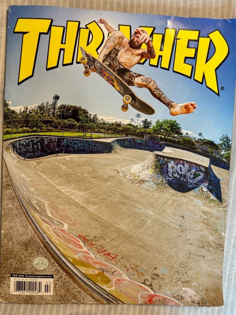 Thrasher Yellow Logo with Skateboarder Launching Over Bowl